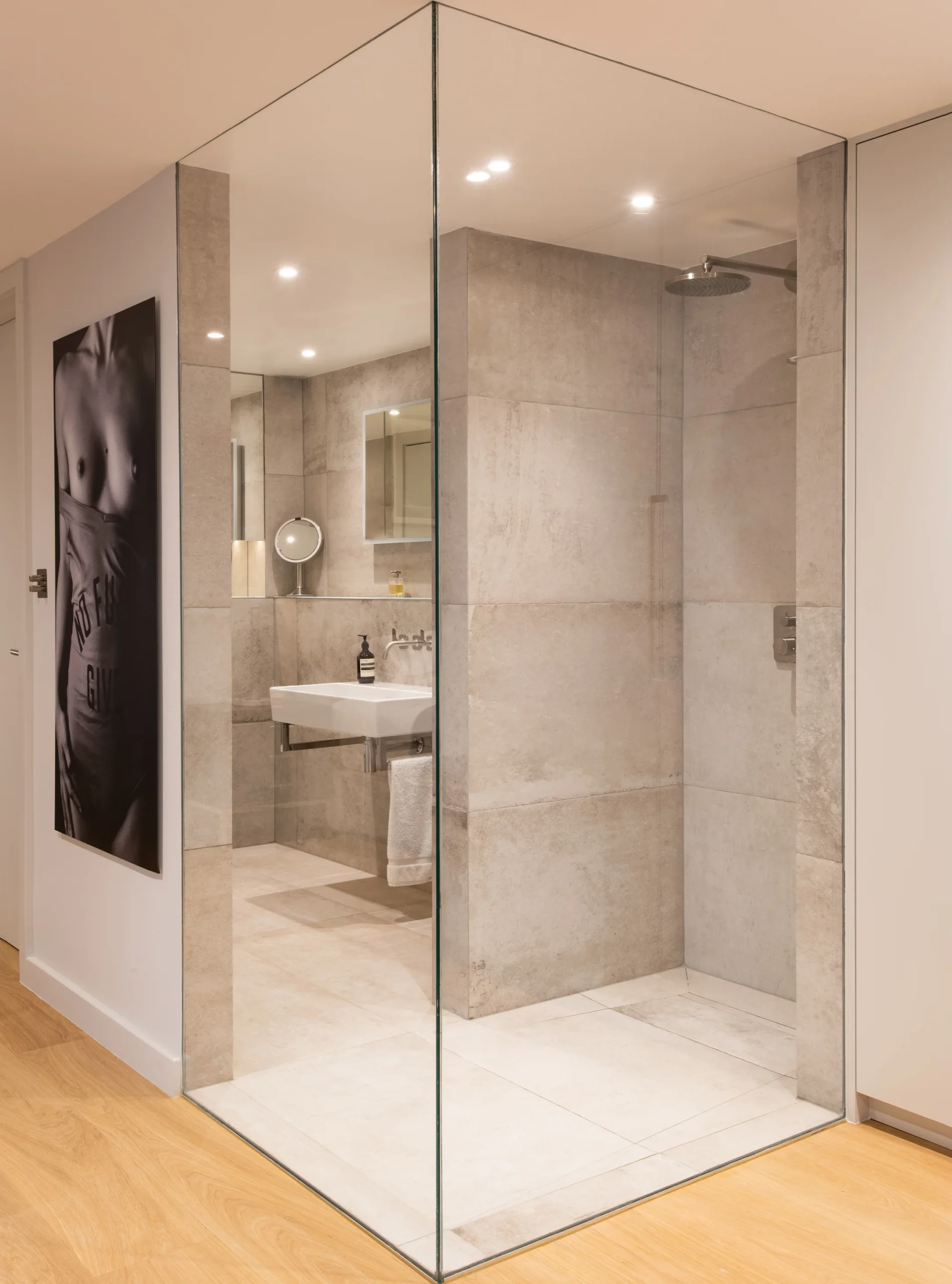 Bathroom with a frameless glass walk-in shower and large-format stone tiles