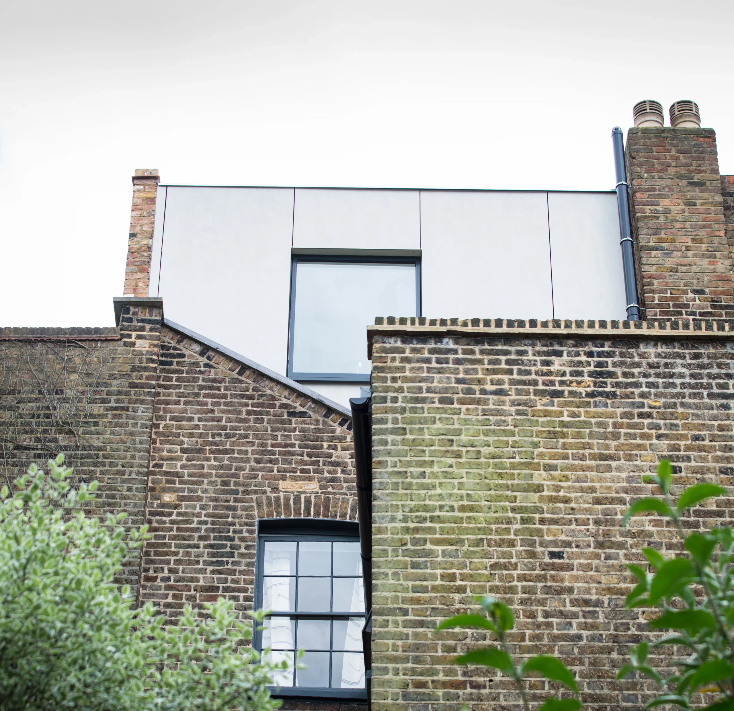 Camden_1_3840px Rear elevation of the Camden terrace showing the clad loft extension above London stock brick