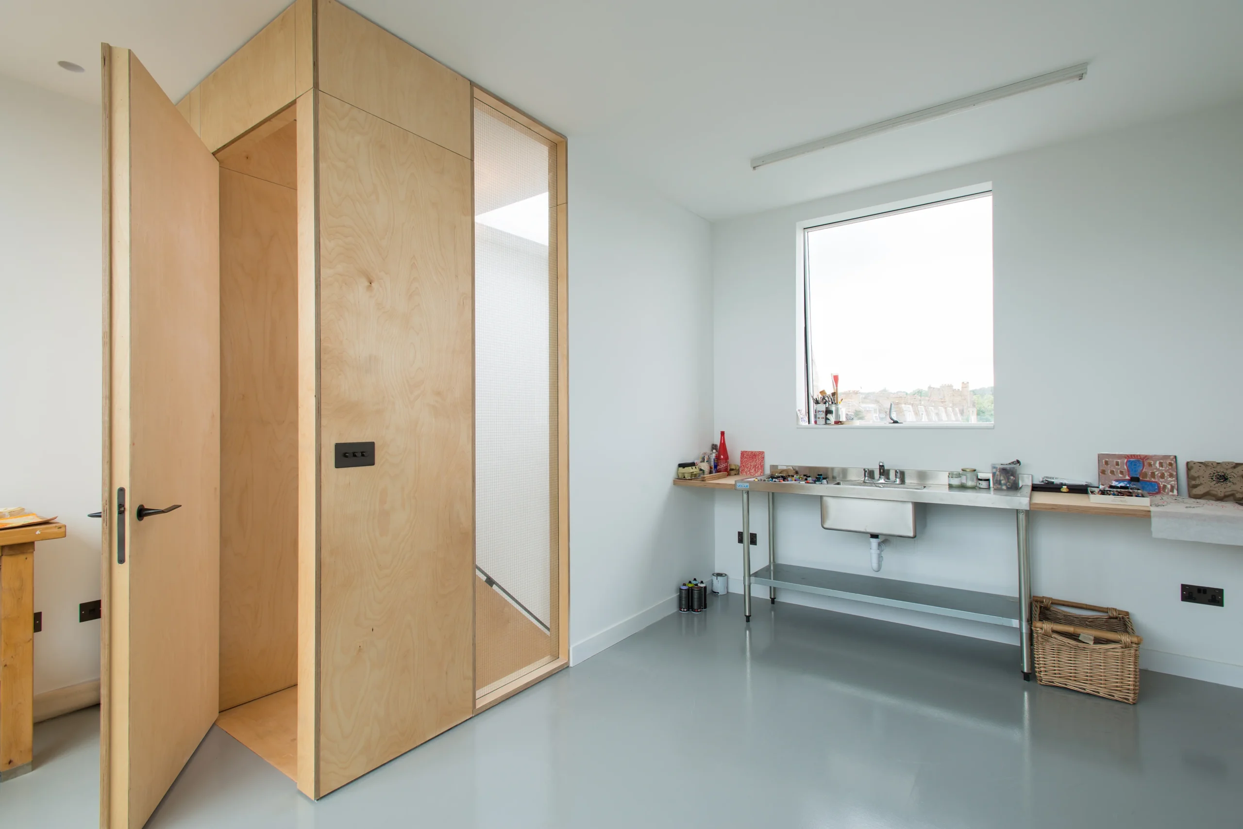 Camden_9_3840px Loft conversion art studio with birch plywood joinery and a concealed door