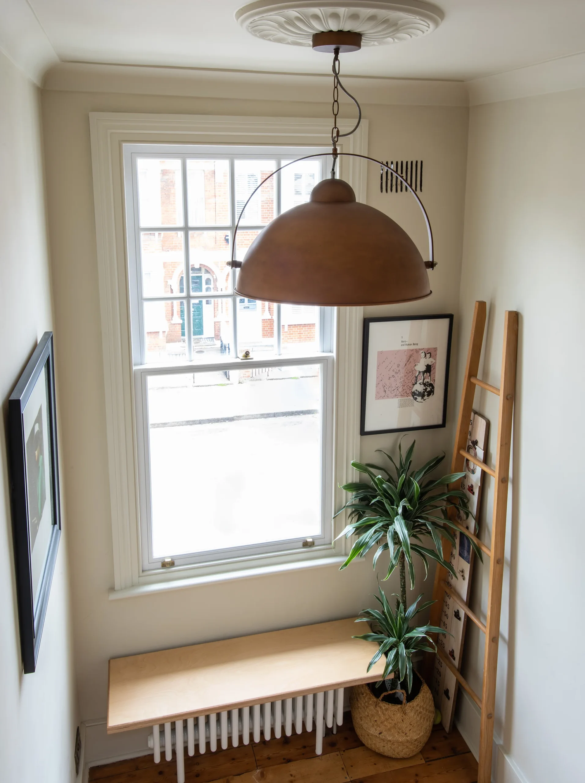 Landing with sash window, copper pendant light and timber window seat