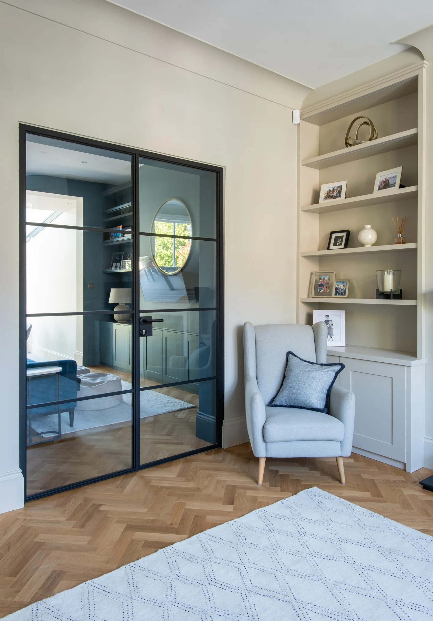 Crittall-style double doors between the reception room and the extension, over herringbone parquet