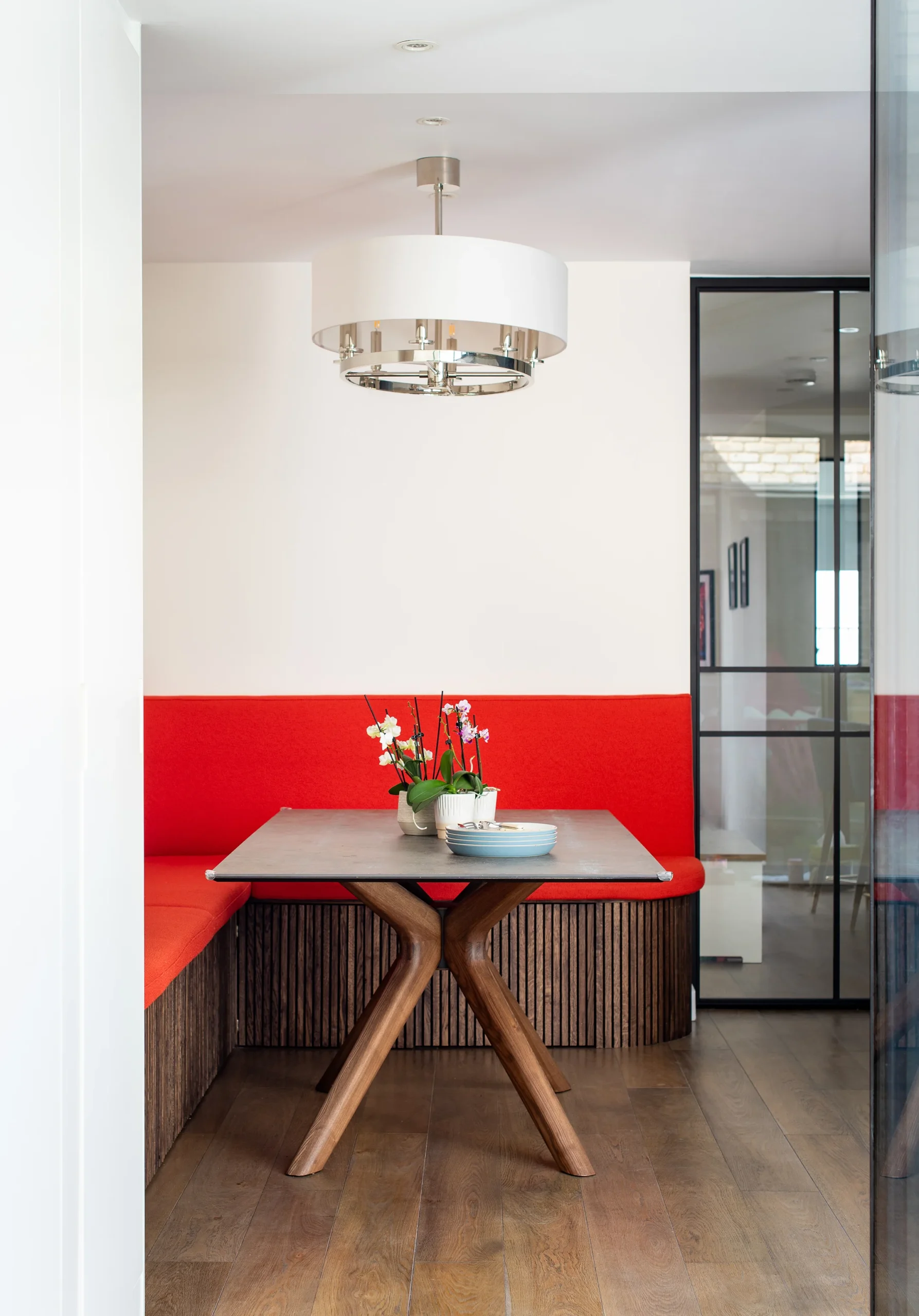 Hafer-Rd_2160px_2 Red upholstered banquette with oak-slatted base beside a stone-topped dining table