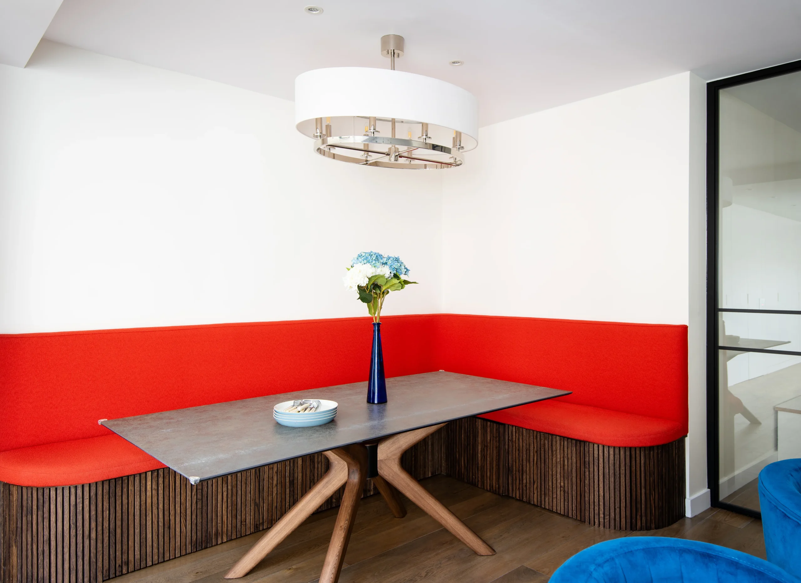 Hafer-Rd_3840px_5 Built-in dining nook with red banquette, oak-slatted base and pendant light