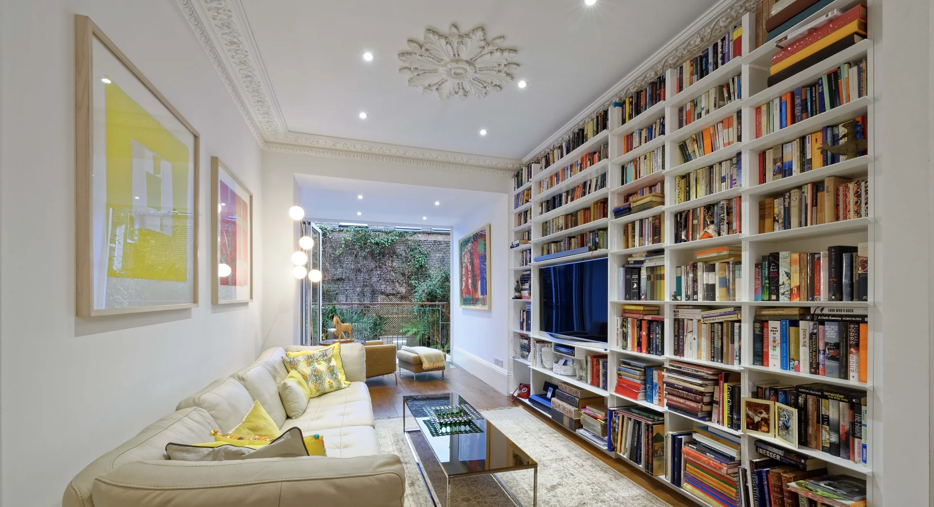 Luxury lounge in Wimbledon with full-wall bespoke bookcase
